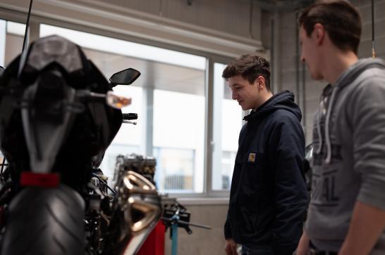Jeunes en formation près d'une moto