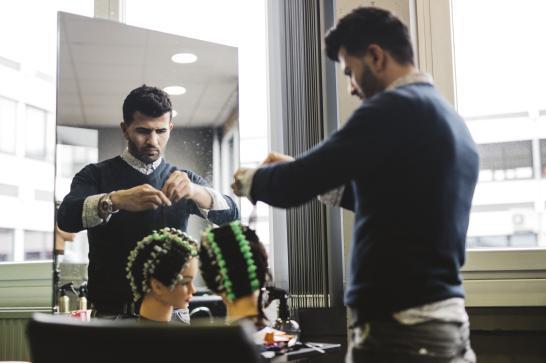 Coiffeur en train de s'entrainer face à un miroir