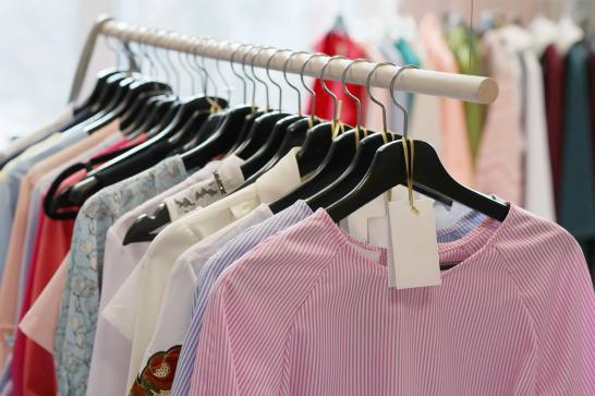 Tringle de vêtements avec une étiquette dans un magasin de prêt-à-porter